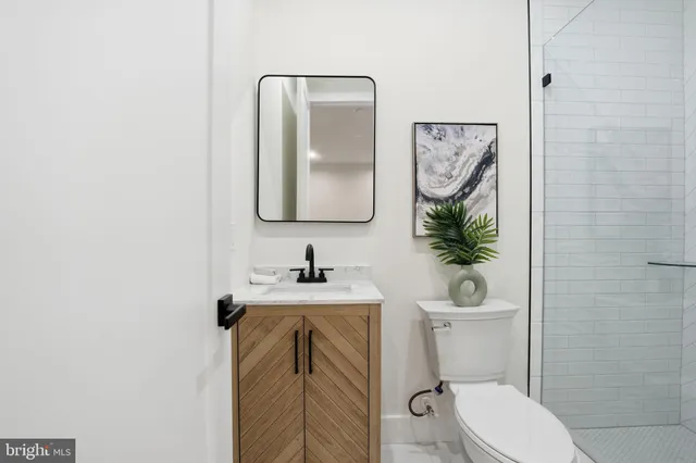 a bathroom with a toilet a sink and mirror