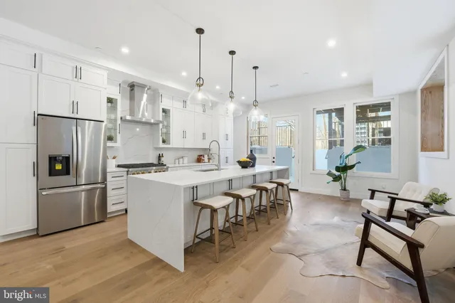 a large kitchen with a table and chairs