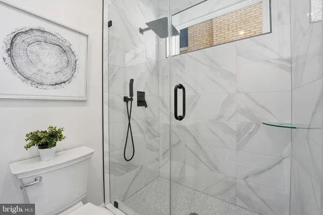 a bathroom with a shower a toilet and a shower