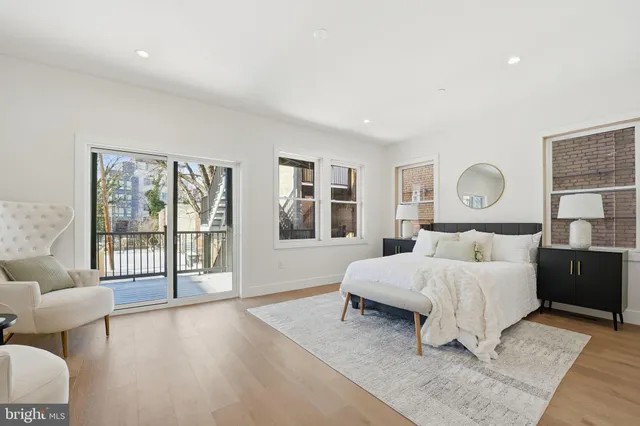 a spacious bedroom with a large bed and a window