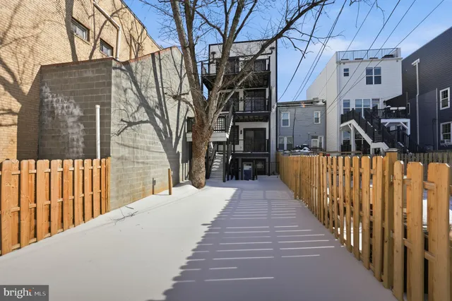 a view of a house with a wooden fence