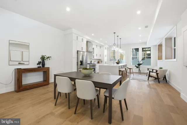 a view of a a dining room with furniture window and wooden floor