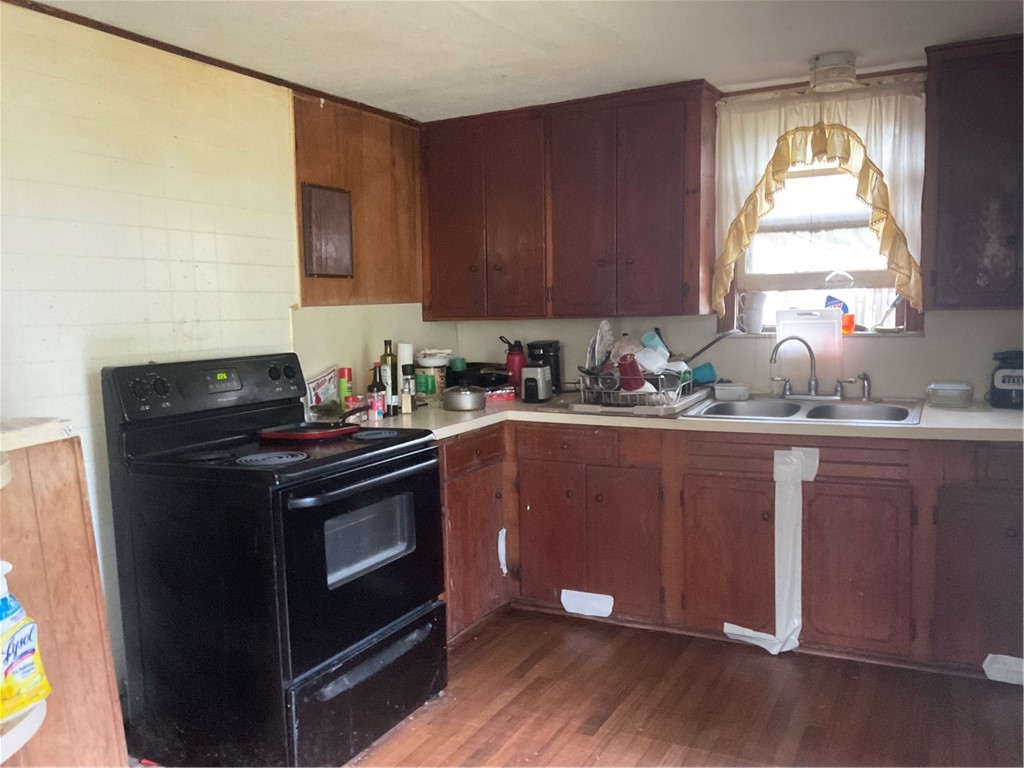 3128 Hackberry Street Ingleside, TX 78362 - Photo 4 of 11 a kitchen with a sink a stove and cabinets