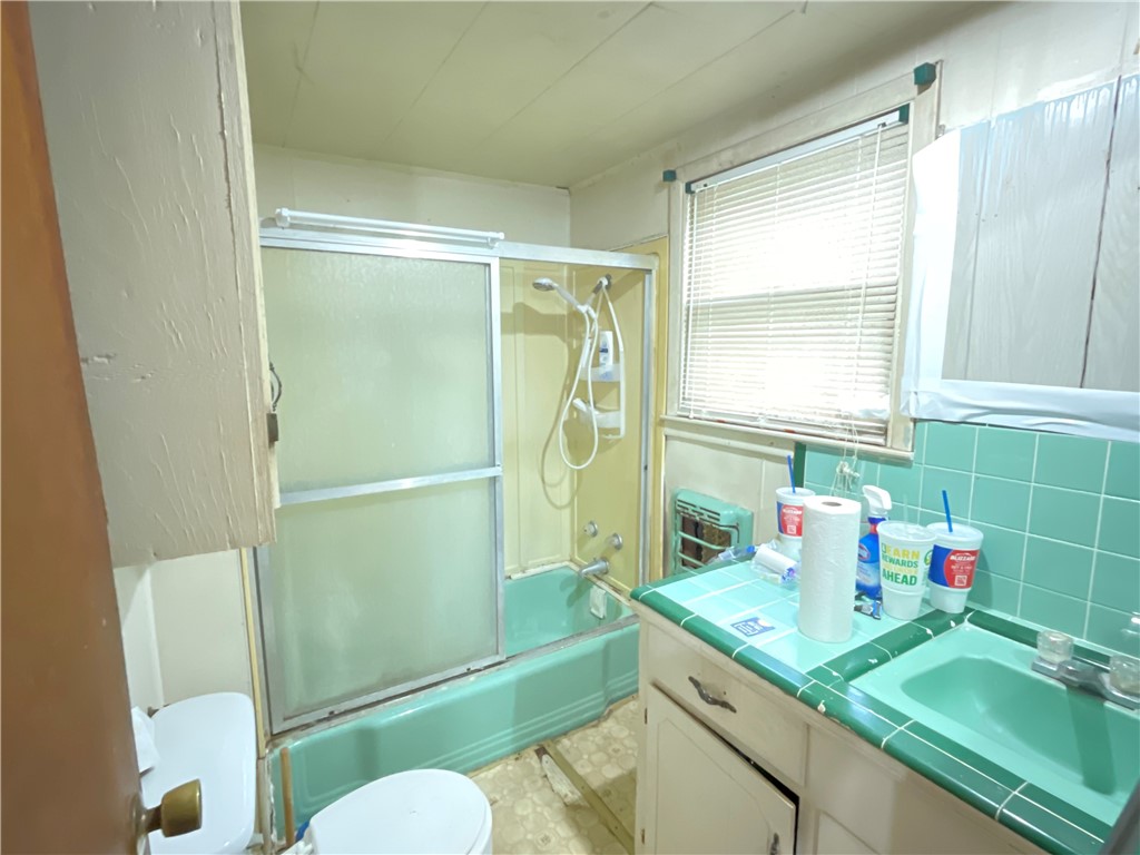 3128 Hackberry Street Ingleside, TX 78362 - Photo 6 of 11 a bathroom with a sink mirror toilet and shower
