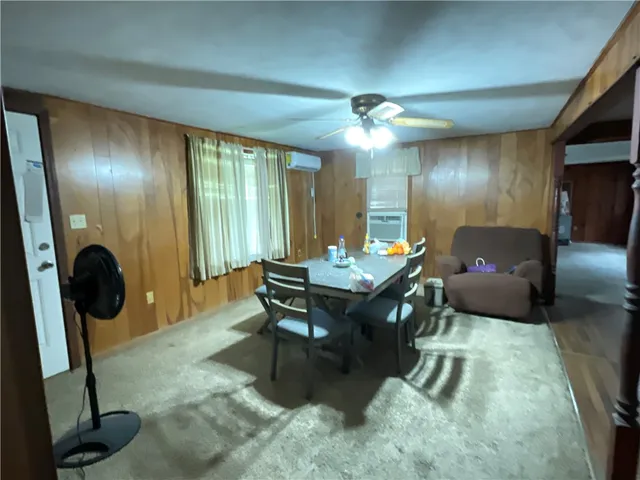 a living room with furniture a lamp and a large window