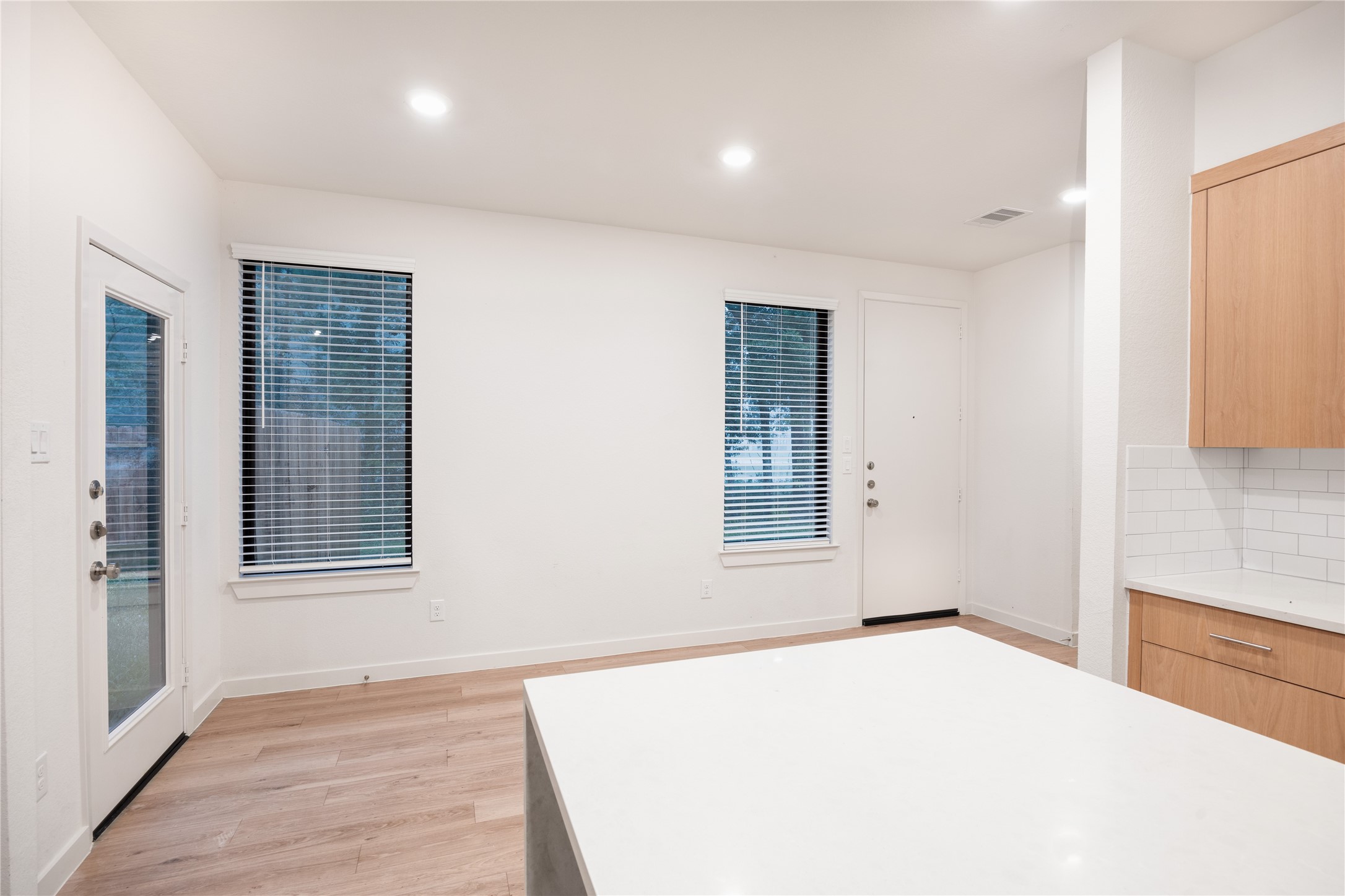 2517 Appian Way, Unit B Roman Forest, TX 77357 - Photo 11 of 31 an empty room with wooden floor and windows