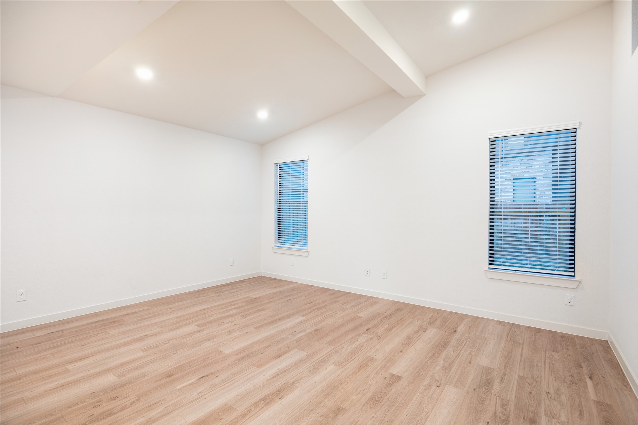 2517 Appian Way, Unit B Roman Forest, TX 77357 - Photo 12 of 31 an empty room with wooden floor and windows