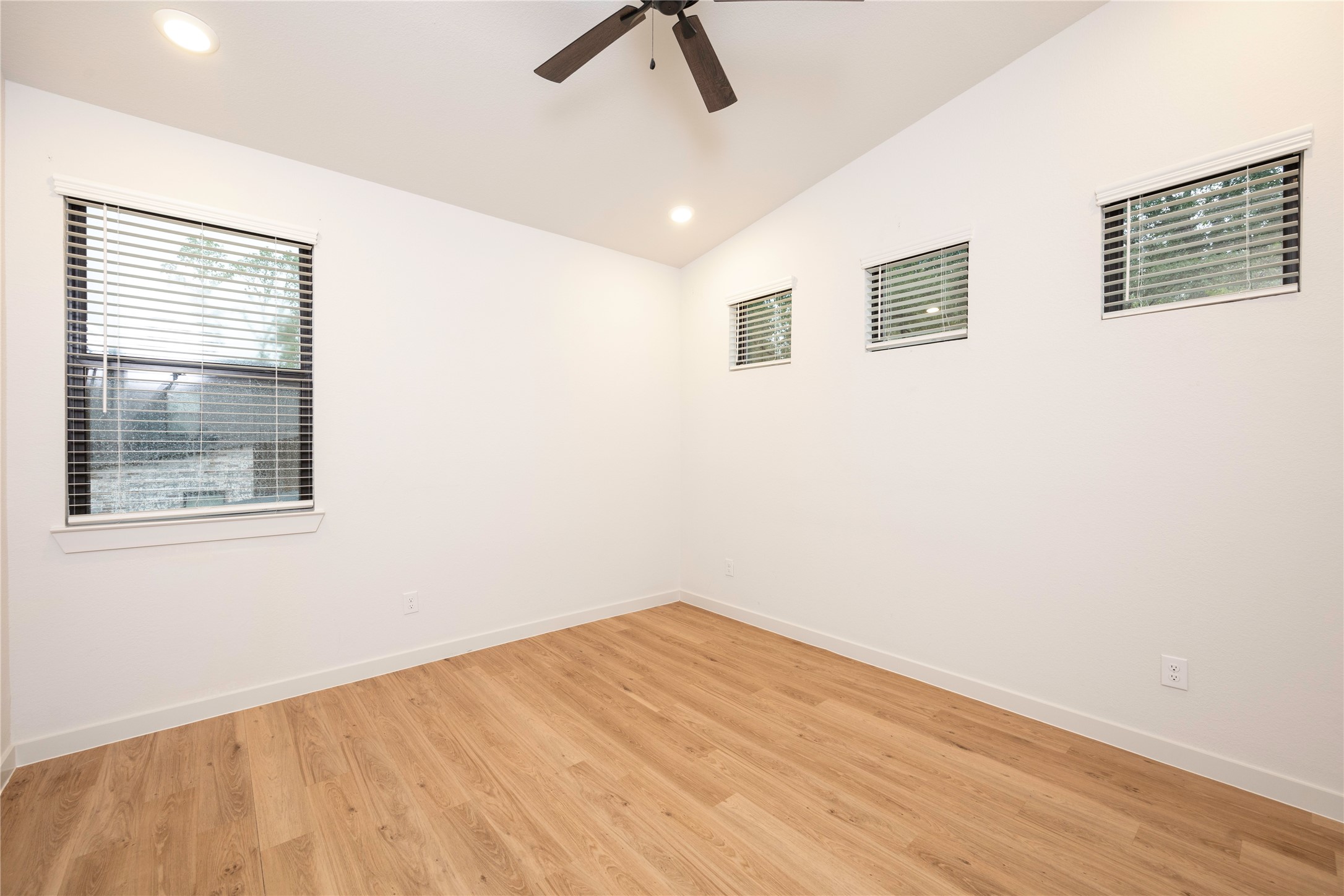 2517 Appian Way, Unit B Roman Forest, TX 77357 - Photo 16 of 31 a view of empty room with wooden floor and fan
