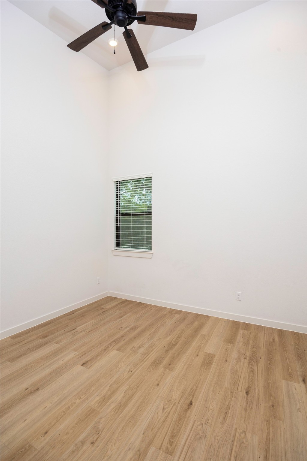 2517 Appian Way, Unit B Roman Forest, TX 77357 - Photo 27 of 31 an empty room with wooden floor and windows