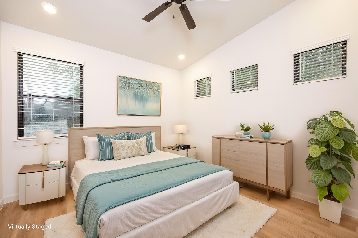 2517 Appian Way, Unit B Roman Forest, TX 77357 - Photo 7 of 37 a bedroom with a large bed and a chandelier