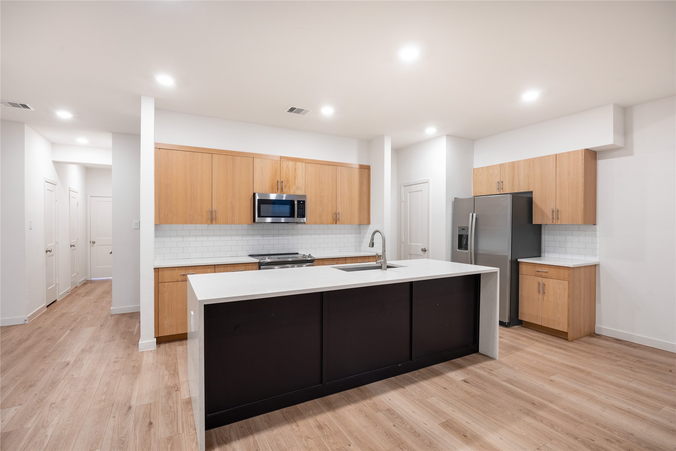 2517 Appian Way, Unit B Roman Forest, TX 77357 - Photo 9 of 31 a kitchen with stainless steel appliances granite countertop a sink stove and refrigerator