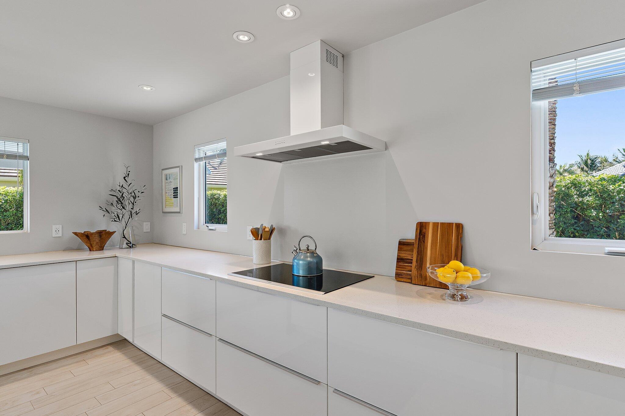 126 Orion Circle Jupiter, FL 33477 - Photo 11 of 82 a kitchen with a sink a counter space and cabinets