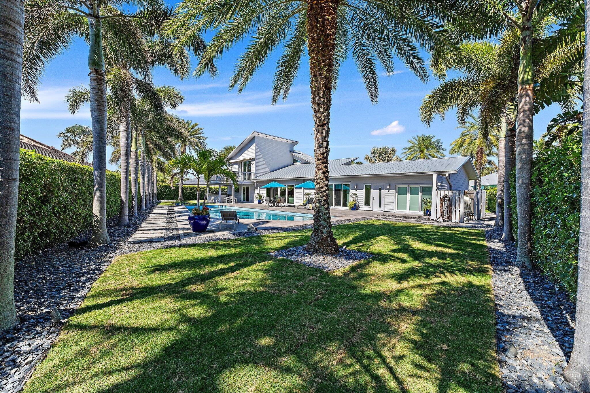 126 Orion Circle Jupiter, FL 33477 - Photo 25 of 82 a front view of house with yard and green space