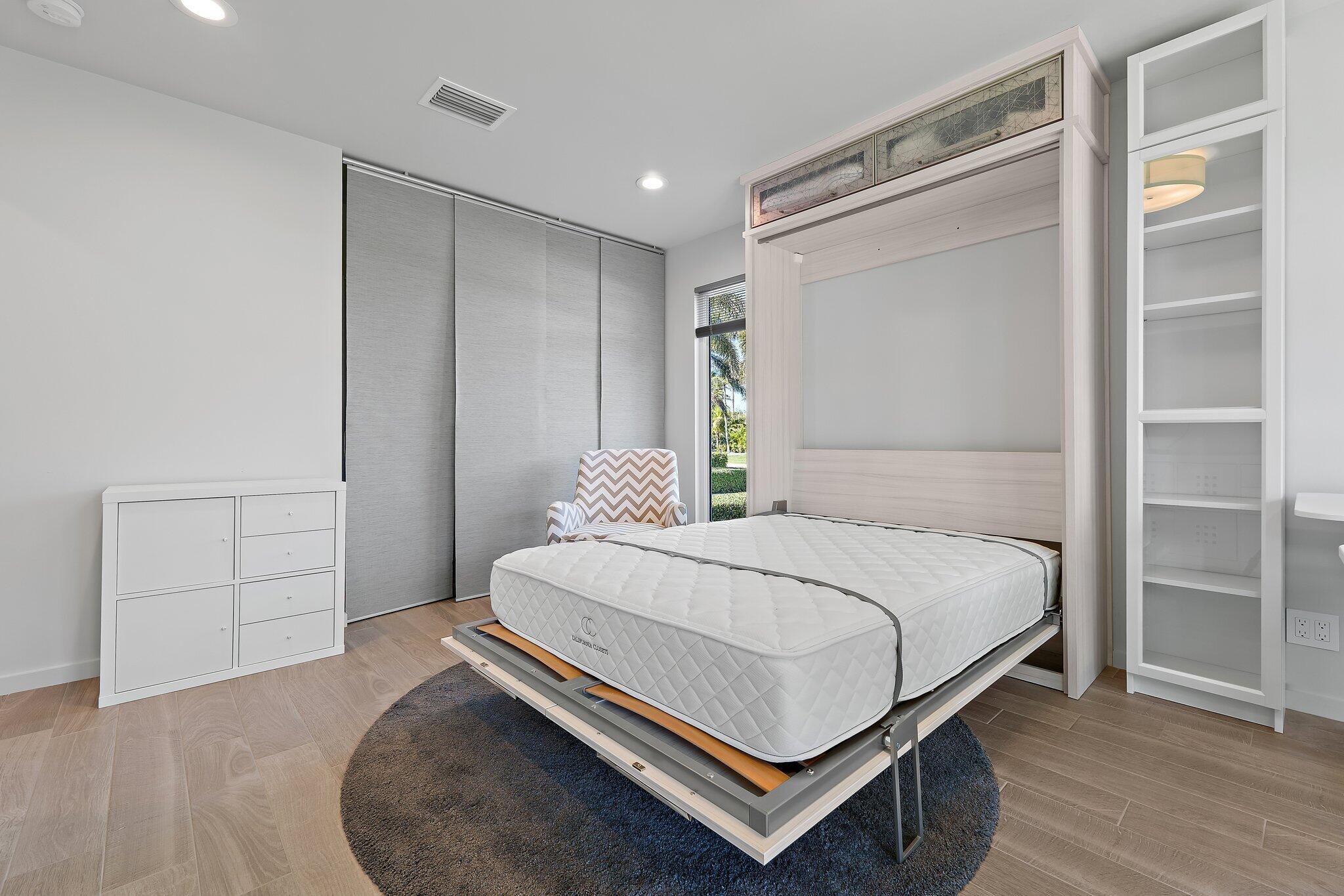 126 Orion Circle Jupiter, FL 33477 - Photo 40 of 82 a bedroom with a bed and cabinet