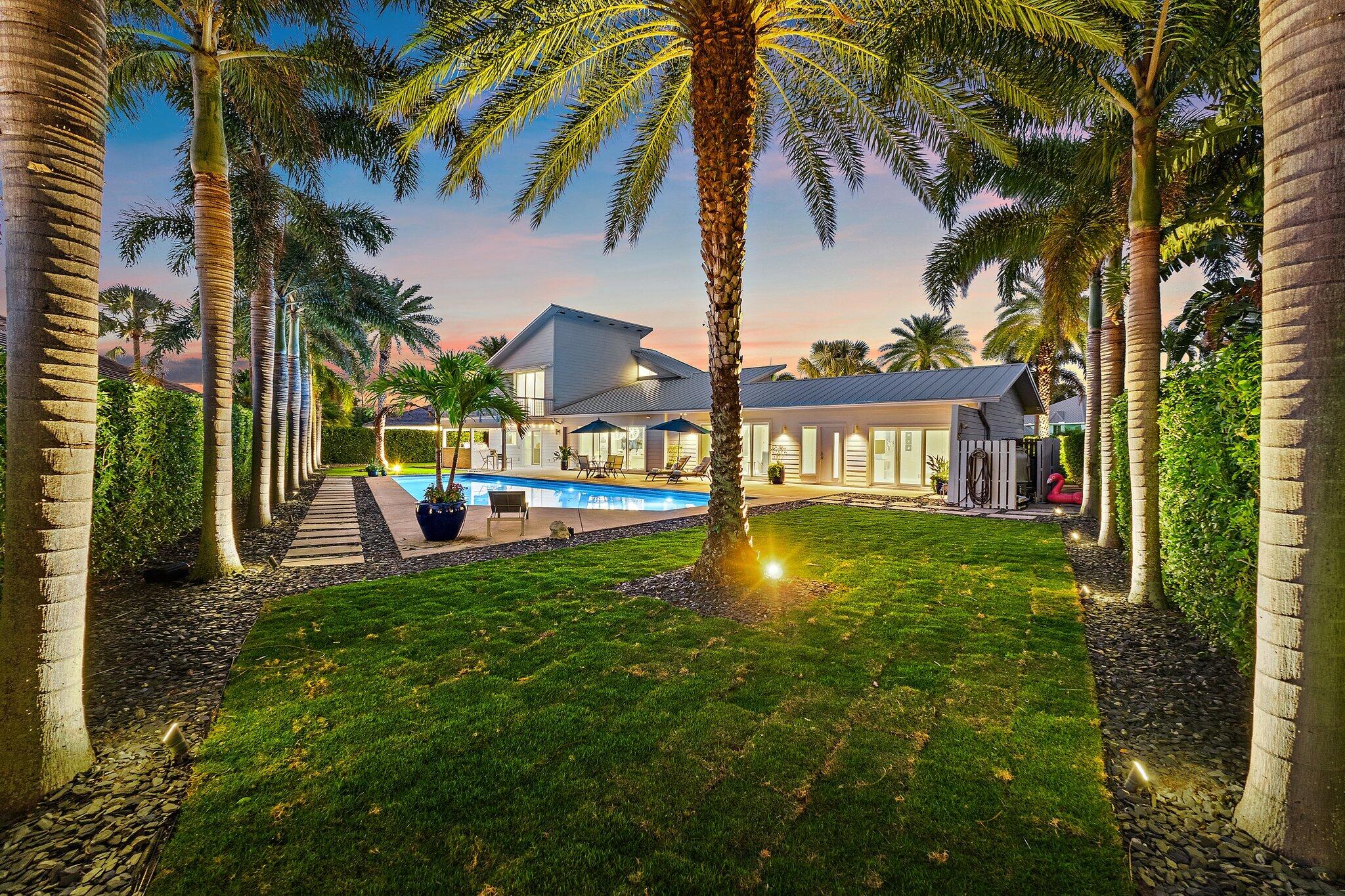 126 Orion Circle Jupiter, FL 33477 - Photo 63 of 82 a view of a house with a swimming pool