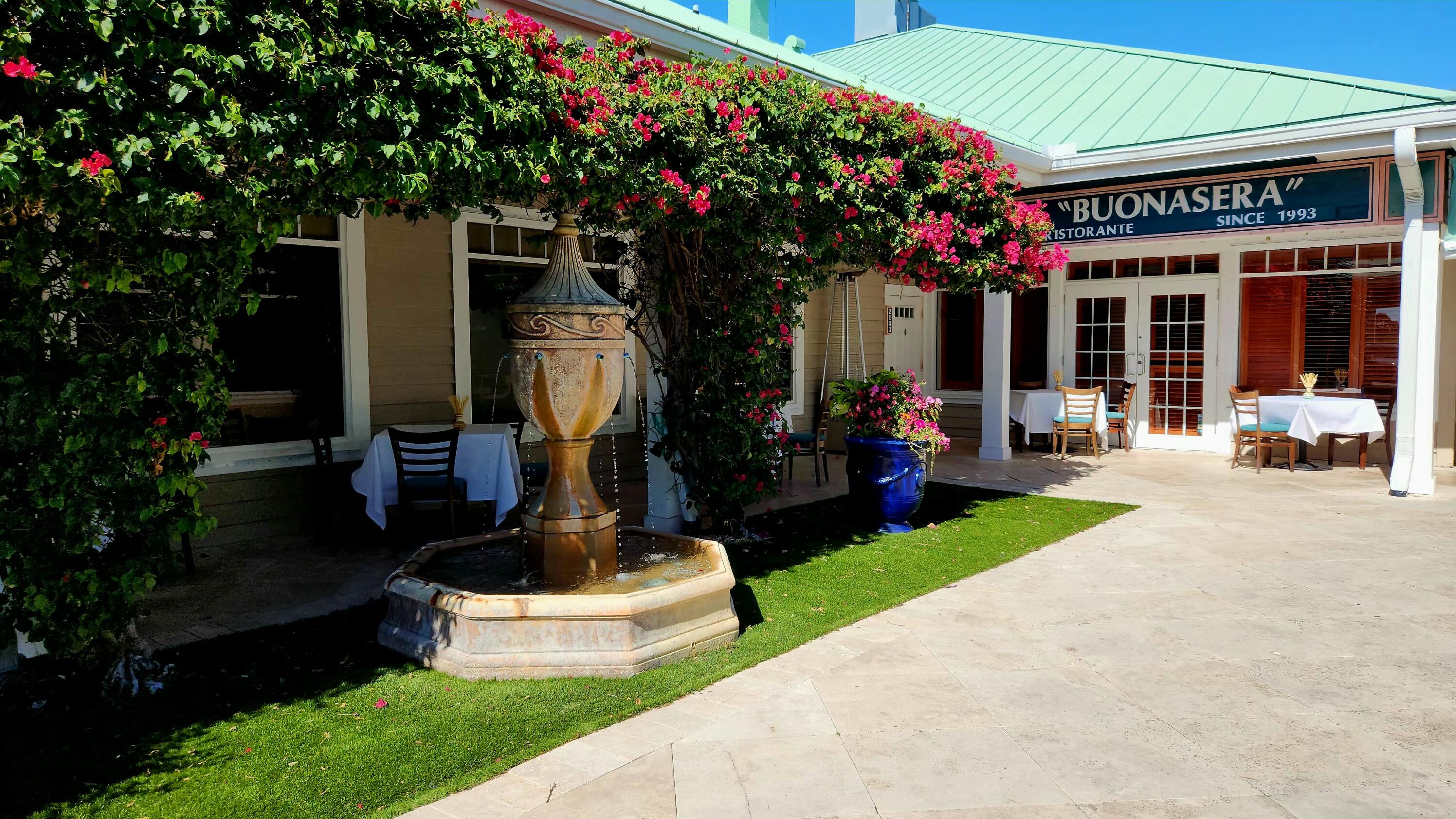 126 Orion Circle Jupiter, FL 33477 - Photo 76 of 82 a front view of a house with fountain and garden