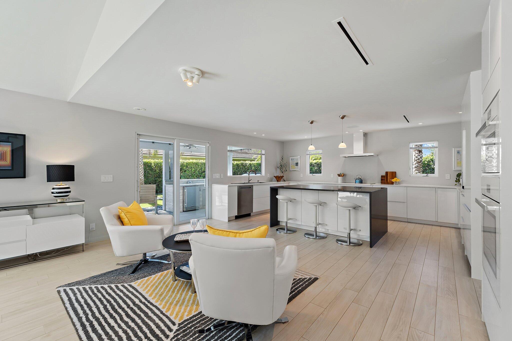 126 Orion Circle Jupiter, FL 33477 - Photo 8 of 82 a living room with furniture and kitchen view with wooden floor