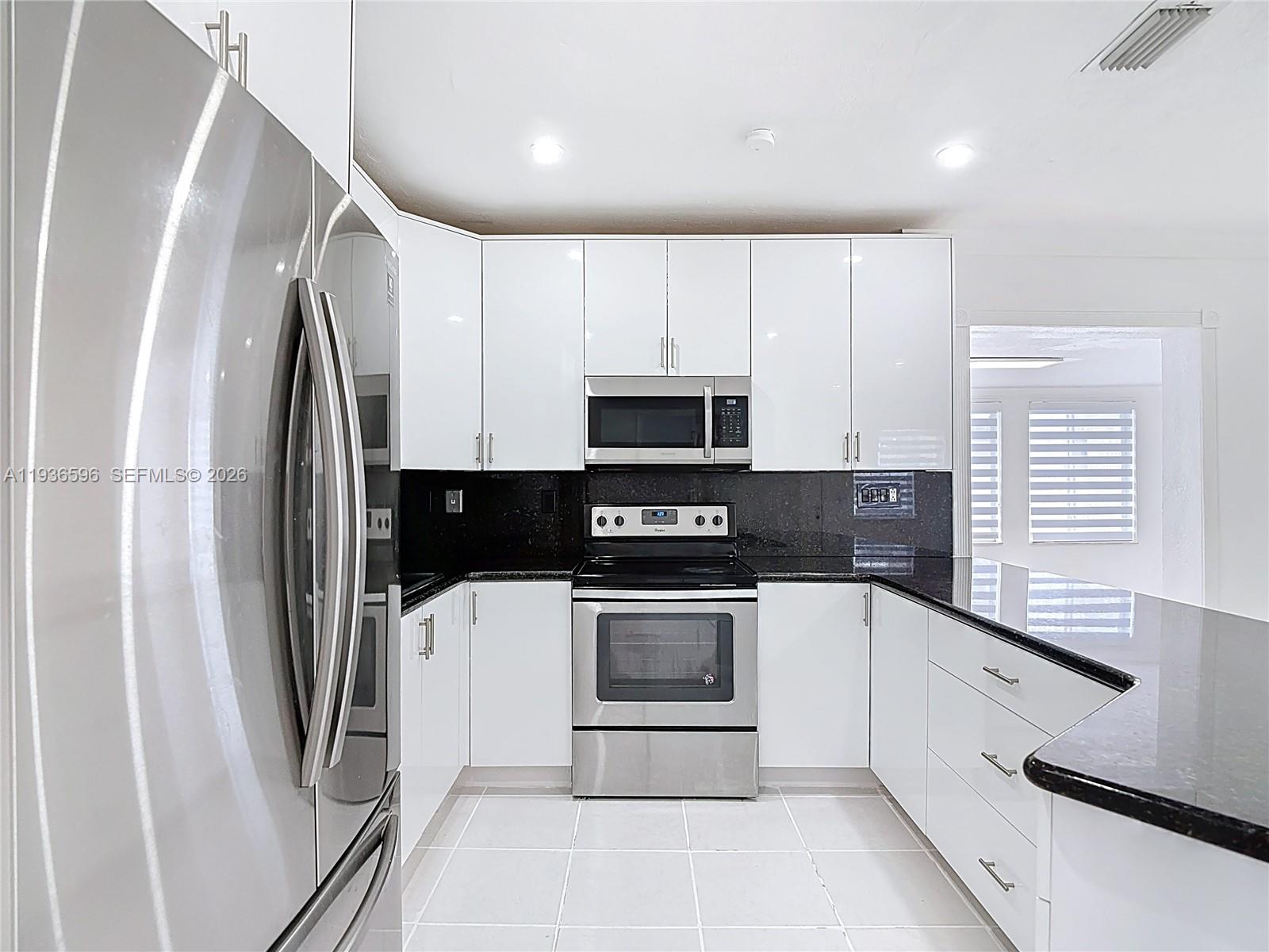 7410 Southwest 39th Street Miami, FL 33155 - Photo 15 of 47 a kitchen with stainless steel appliances a refrigerator sink and microwave