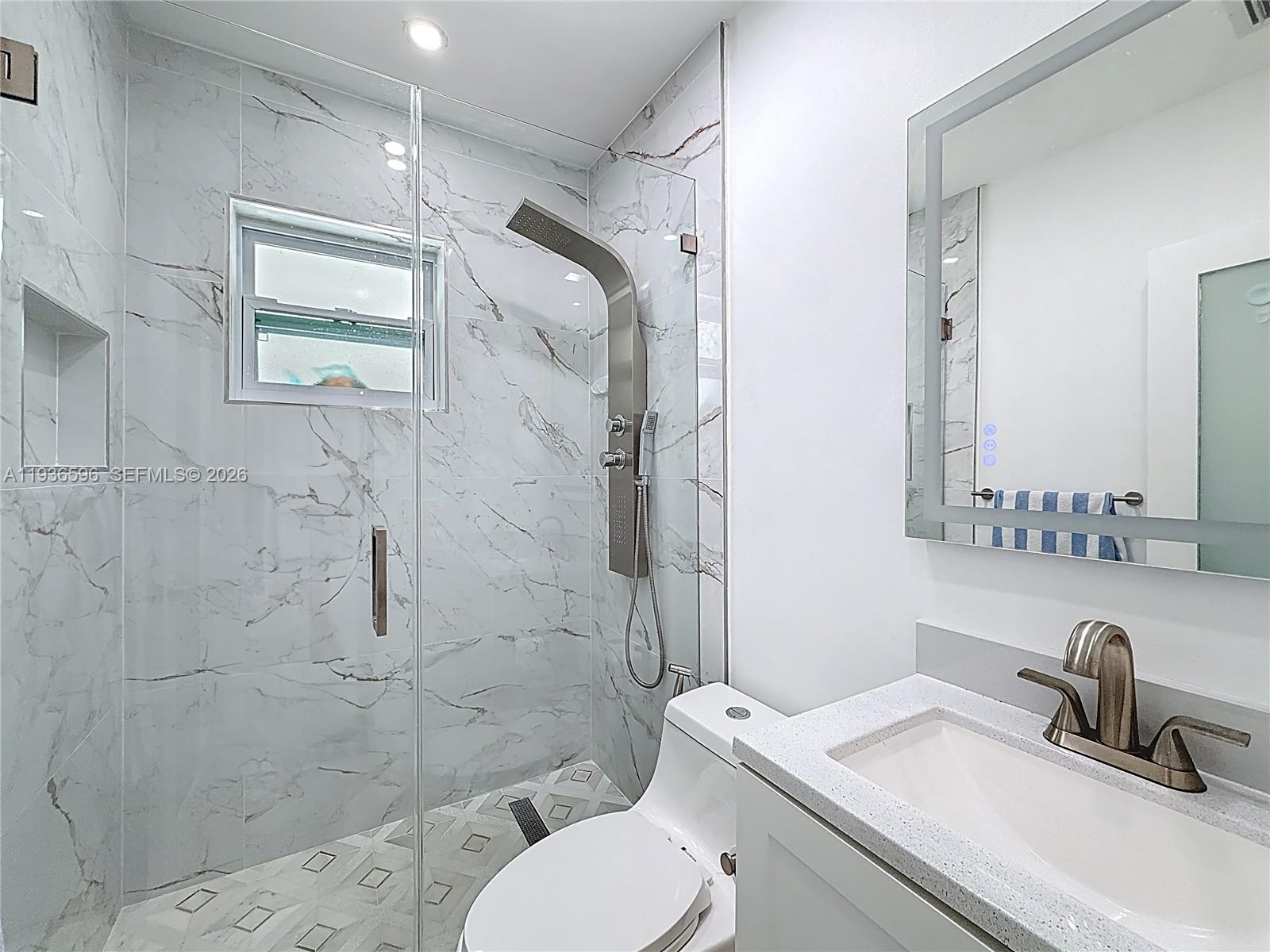 7410 Southwest 39th Street Miami, FL 33155 - Photo 25 of 47 a bathroom with a sink toilet a mirror and shower
