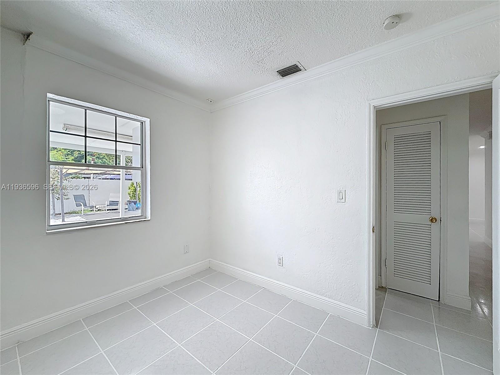 7410 Southwest 39th Street Miami, FL 33155 - Photo 27 of 47 an empty room with windows and closet