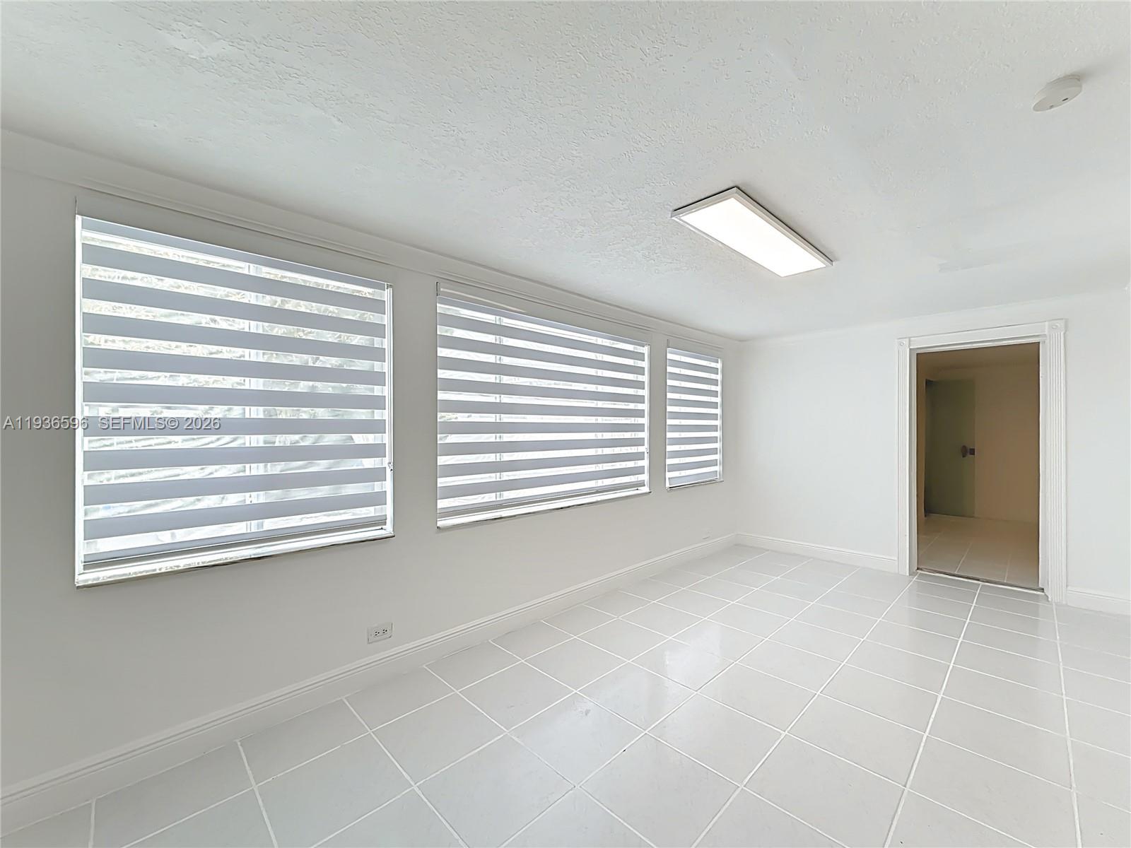 7410 Southwest 39th Street Miami, FL 33155 - Photo 29 of 47 a view of an empty room with a window