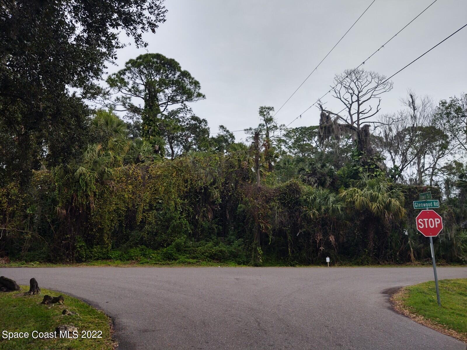 7412 Glenwood Road Cocoa, FL 32927 - Photo 2 of 6 a street sign on a sidewalk next to a road