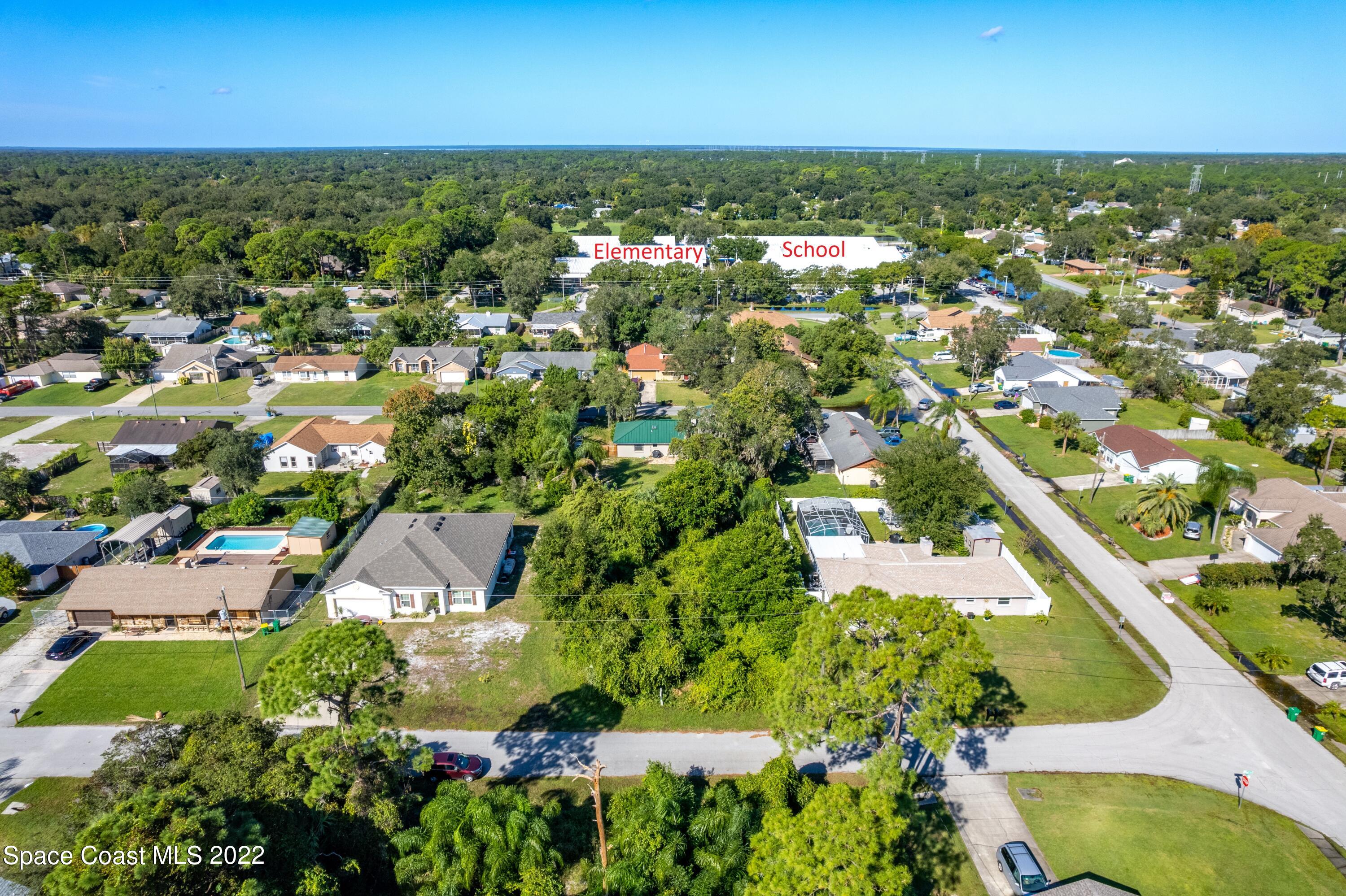 7412 Glenwood Road Cocoa, FL 32927 - Photo 5 of 6 an aerial view of residential houses with outdoor space and trees
