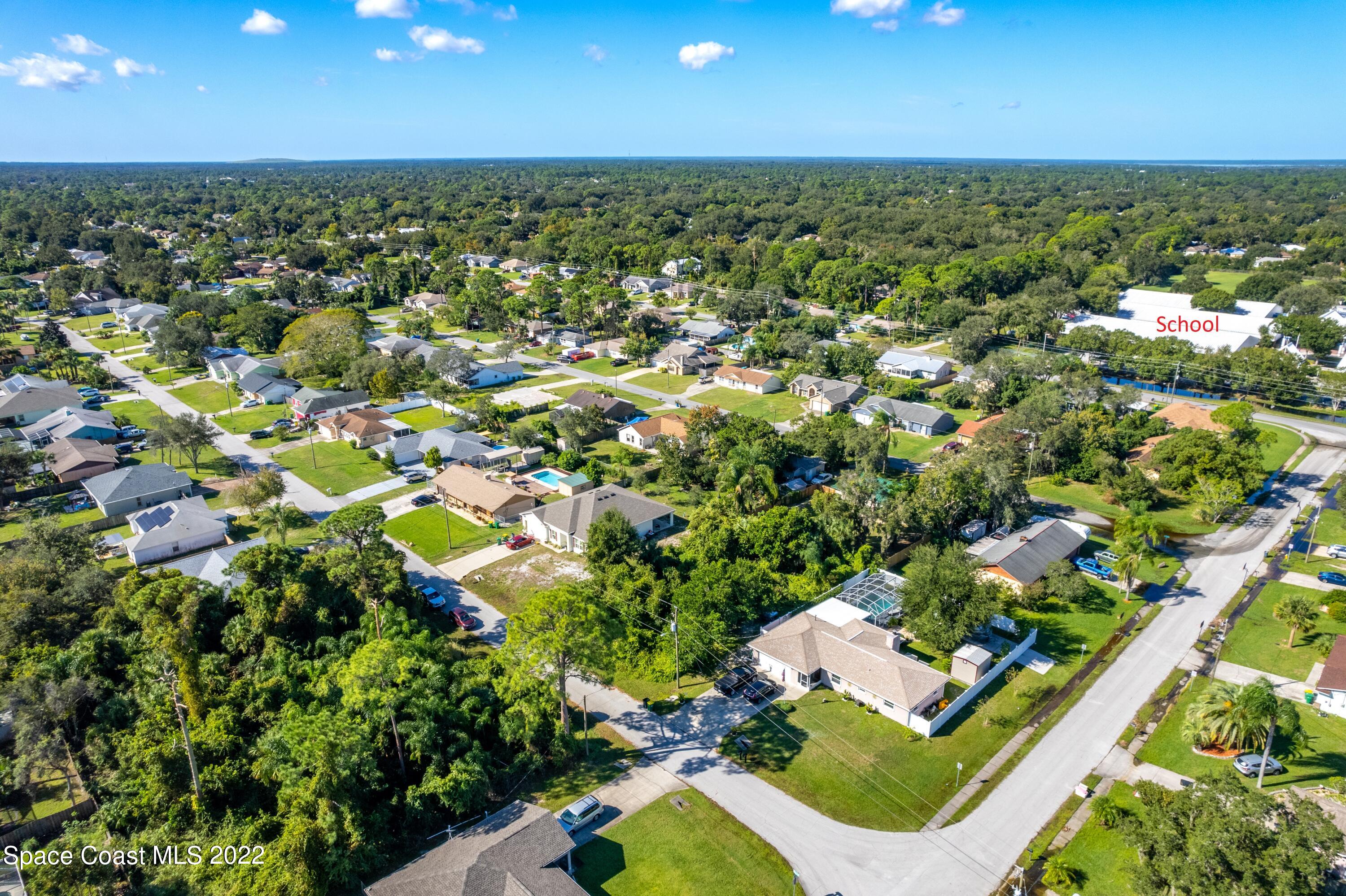 7412 Glenwood Road Cocoa, FL 32927 - Photo 6 of 6 an aerial view of residential houses with outdoor space and trees