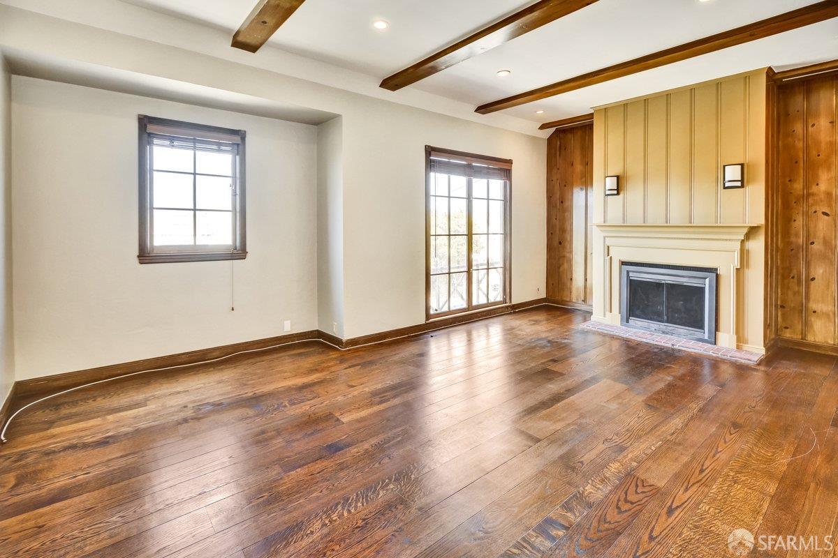1770 17th Avenue San Francisco, CA 94122 - Photo 1 of 31 an empty room with wooden floor fireplace and windows
