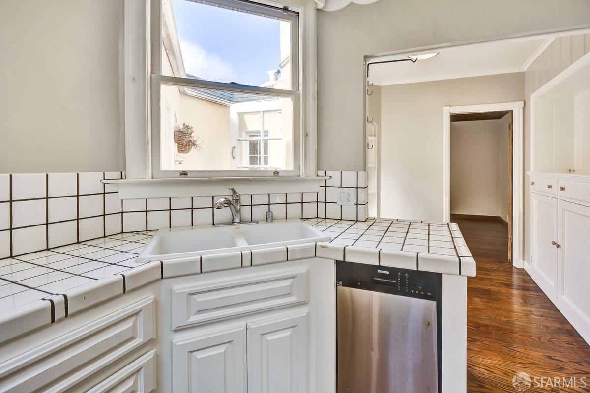1770 17th Avenue San Francisco, CA 94122 - Photo 12 of 31 a kitchen with a stove a sink and a window