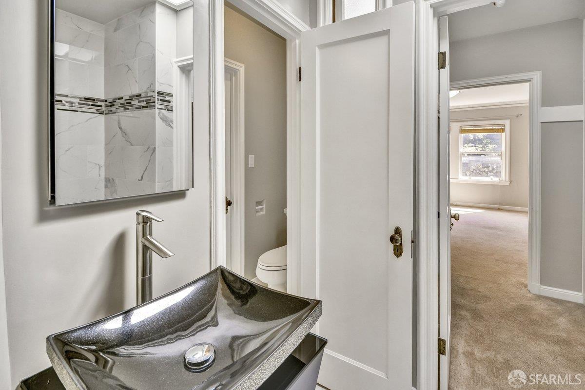 1770 17th Avenue San Francisco, CA 94122 - Photo 18 of 31 a bathroom with a sink and a mirror