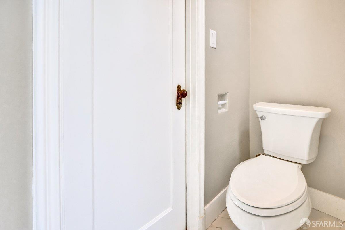 1770 17th Avenue San Francisco, CA 94122 - Photo 19 of 31 a white toilet sitting next to a shower