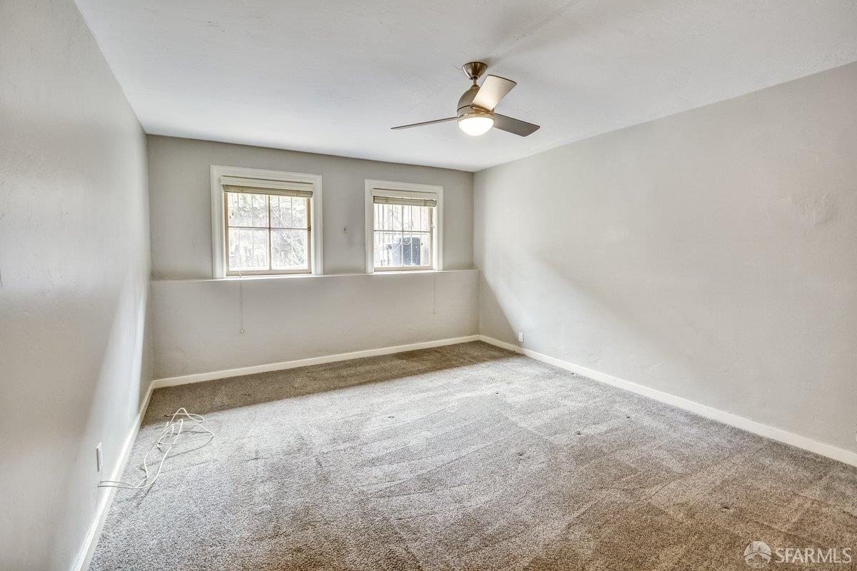 1770 17th Avenue San Francisco, CA 94122 - Photo 20 of 31 an empty room with windows and chandelier fan