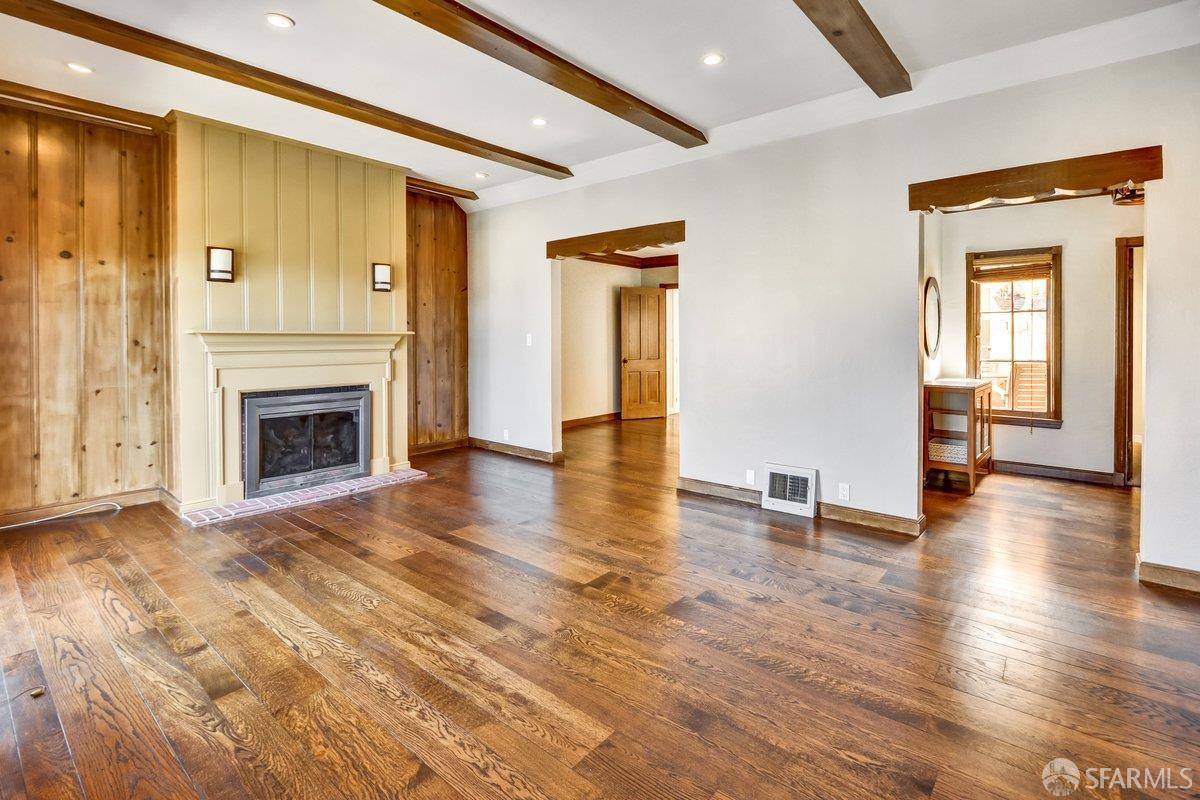 1770 17th Avenue San Francisco, CA 94122 - Photo 2 of 31 a view of a livingroom with wooden floor and a fireplace