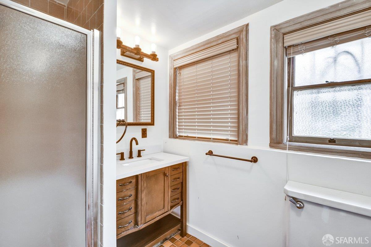 1770 17th Avenue San Francisco, CA 94122 - Photo 26 of 31 a bathroom with a sink a mirror and a window