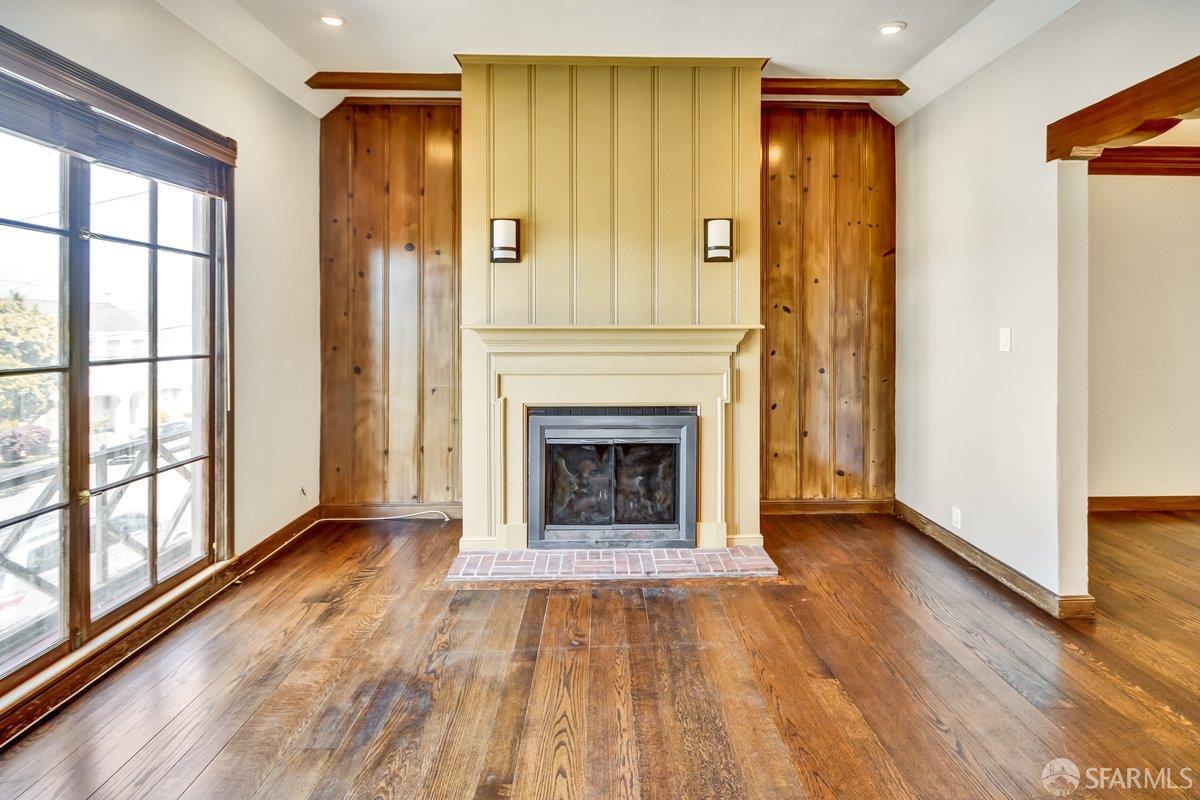 1770 17th Avenue San Francisco, CA 94122 - Photo 3 of 31 a view of a livingroom with wooden floor a fireplace and window