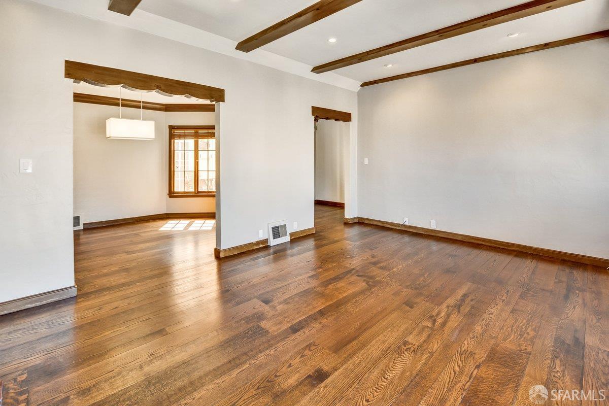 1770 17th Avenue San Francisco, CA 94122 - Photo 4 of 31 a view of an empty room with window and wooden floor