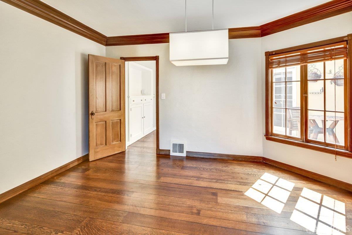1770 17th Avenue San Francisco, CA 94122 - Photo 5 of 31 a view of an empty room with wooden floor and a window