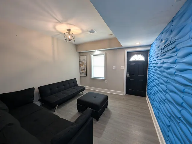 a living room with furniture and a chandelier