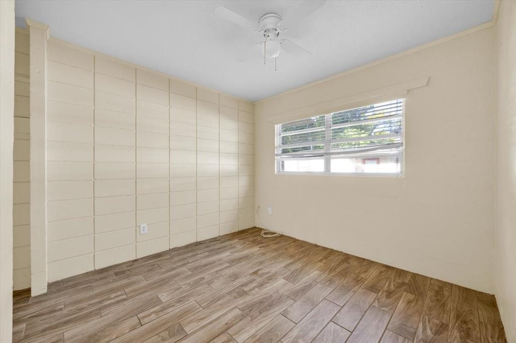 757-797 Roane Road Clermont, FL 34711 - Photo 13 of 17 a view of an empty room with wooden floor and a window