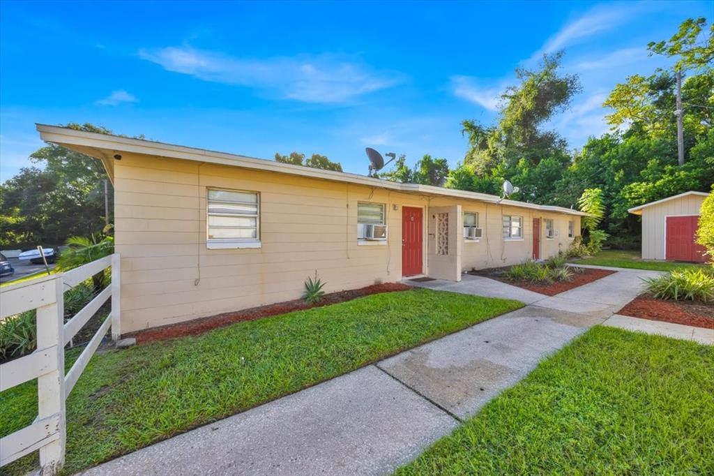 757-797 Roane Road Clermont, FL 34711 - Photo 8 of 17 a front view of a house with a garden
