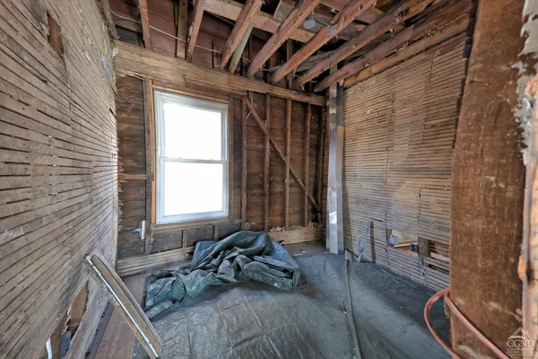 a bed sitting in a room next to a window