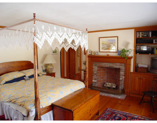 191 Wilder Road Bolton, MA 01740 - Photo 4 of 8 a bedroom with a bed and a fireplace