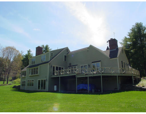 191 Wilder Road Bolton, MA 01740 - Photo 8 of 8 a front view of a house with a garden and plants