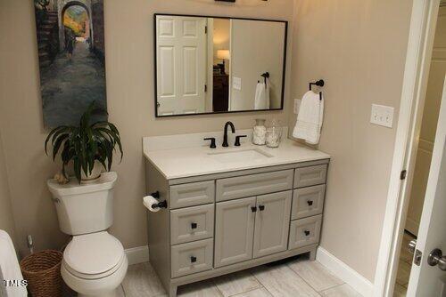 568 Log Barn Road Pittsboro, NC 27312 - Photo 16 of 25 a bathroom with a toilet sink and mirror