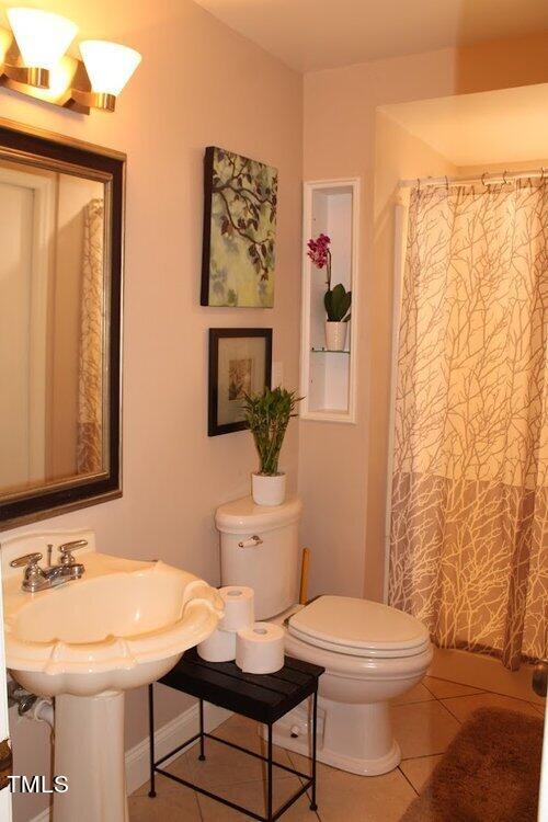 568 Log Barn Road Pittsboro, NC 27312 - Photo 6 of 25 a bathroom with a toilet a sink and a mirror