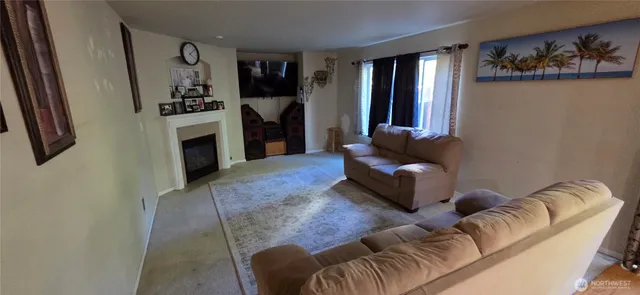 a living room with furniture fireplace and window
