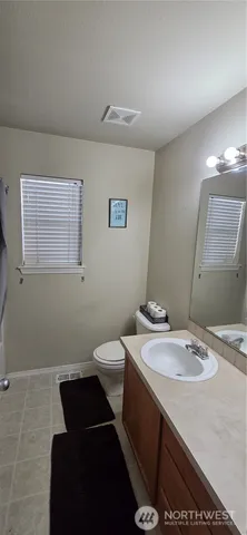 a bathroom with a sink toilet and mirror
