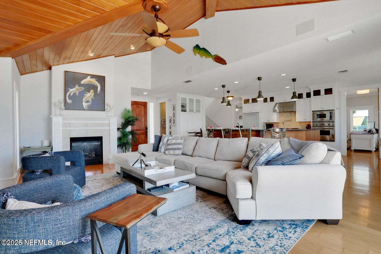1403 Ocean Front Neptune Beach, FL 32266 - Photo 13 of 37 a living room with furniture kitchen view and a fireplace
