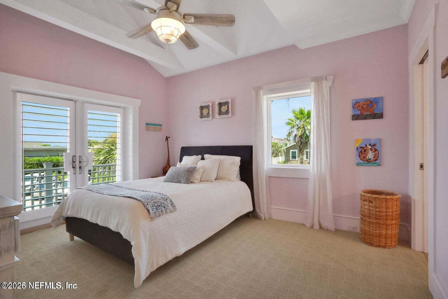 1403 Ocean Front Neptune Beach, FL 32266 - Photo 14 of 37 a bedroom with a bed and a chandelier